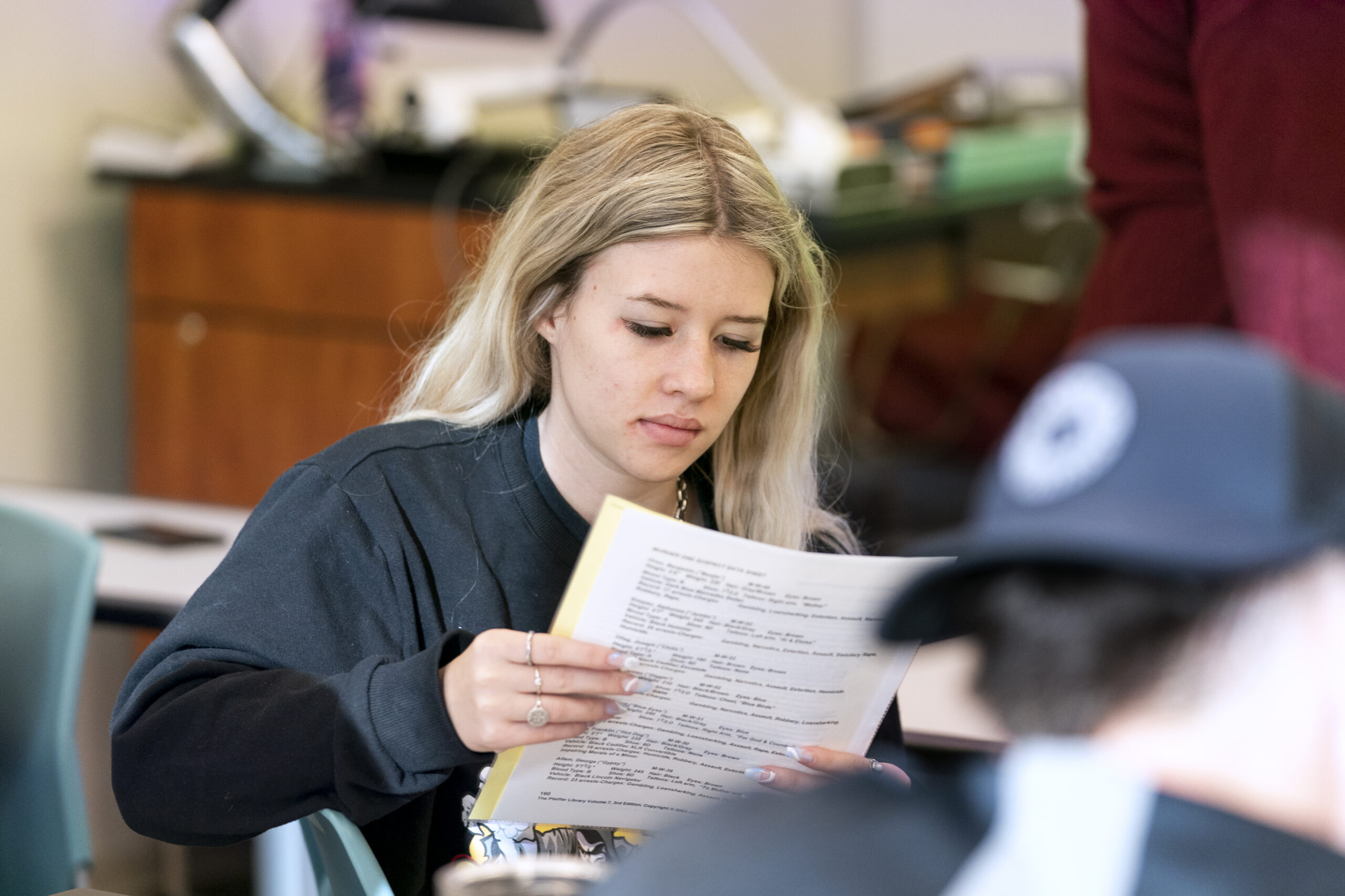Student closely examing a paper.