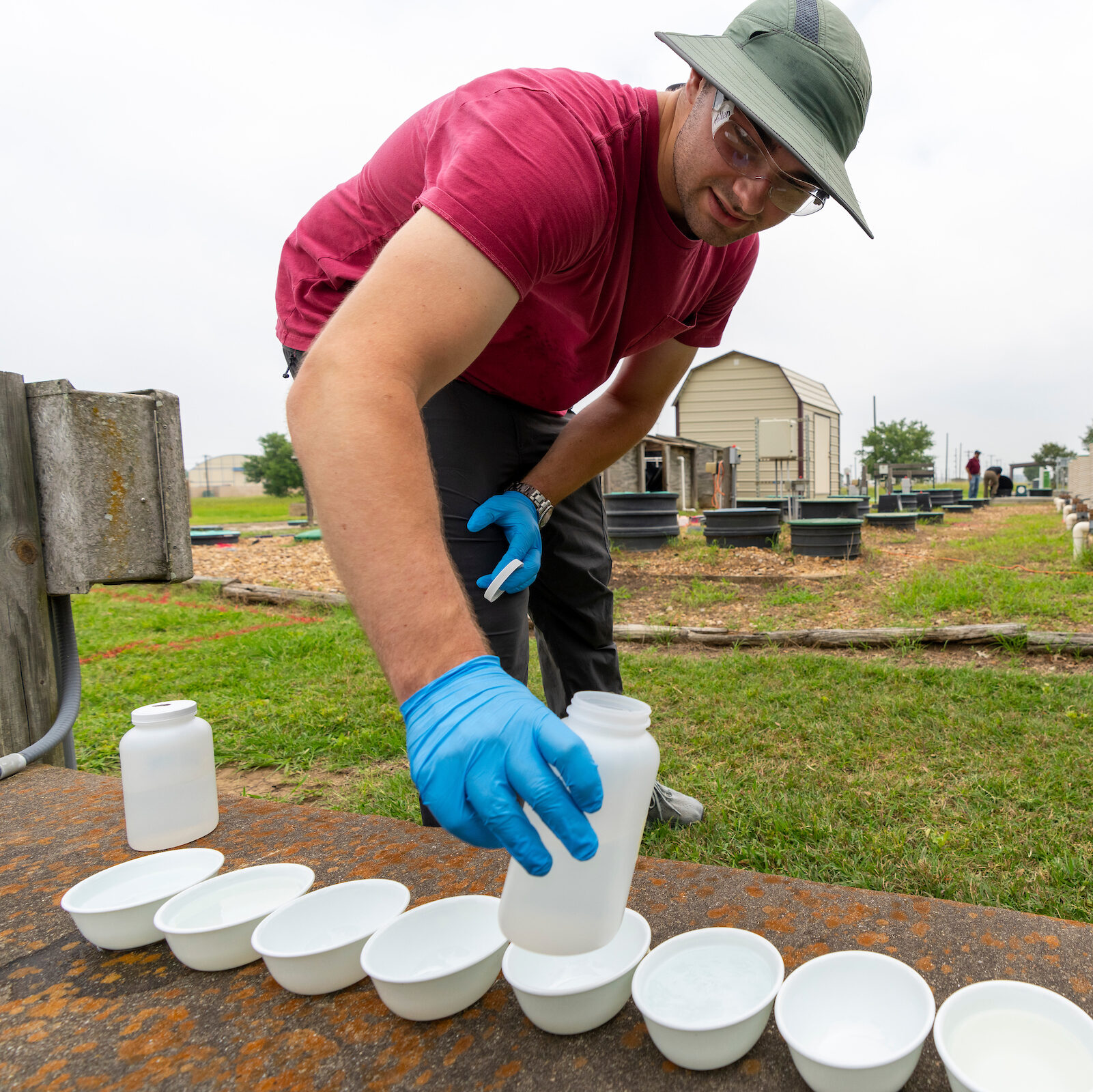 Student conducting an experiment in a field.