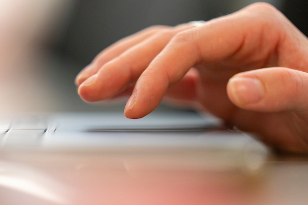 Hands typing on a keyboard.