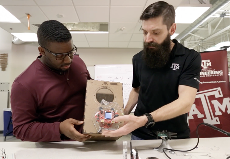 Two engineering students building a model